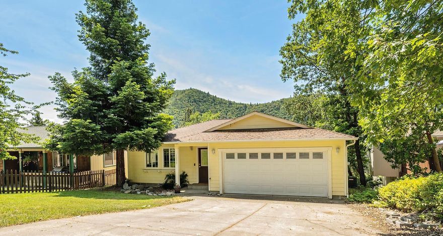 Welcome to this charming move-in ready home in a quiet neighborhood! This 3 bedroom, 2 bath, 1380 square foot home features a large living room that opens to the light and bright dining area, with access to the deck, and adjacent U-shaped kitchen featuring granite counters, stainless steal appliances and plenty of storage. The living area, master bedroom and attached 2 car garage are all located on the main level. Downstairs in the daylight basement you will find 2 nice size guest rooms, full guest bathroom and laundry room. The backyard is sloped with tall trees and mature landscaping that offers plenty of privacy.