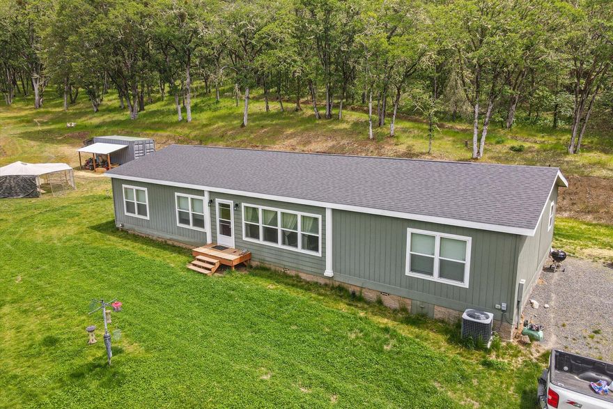 10+/-ACRES - 60+/-GPM WELL - BACKS TO BLM - RV PAD. Beautifully, well-maintained home features premium finishes, modern amenities, and a spacious open floor plan, NEW SUNROOM addition! Property boasts a high-capacity 60+/- GPM well providing abundant water to the mostly level open pasture protected by forested elevation & end-of-road privacy. Backing to 100+/- acres of BLM land, offering unparalleled privacy, stunning views & access to outdoor recreation. Outbuildings provide storage/workspace, while the existing RV pad accommodates your RV. There's outbuildings and plenty of room for animals, gardening, and outdoor activities. The land's private setting makes it ideal for nature lovers seeking tranquility and space. Upgraded energy-efficient windows & upgraded appliances. Perfectly positioned for both rural living and convenient access to local amenities, this property is a rare find for those wanting space, privacy, and outdoor fun. NO DRIVE-BY, DO NOT GO TO PROPERTY WITHOUT AGENT.