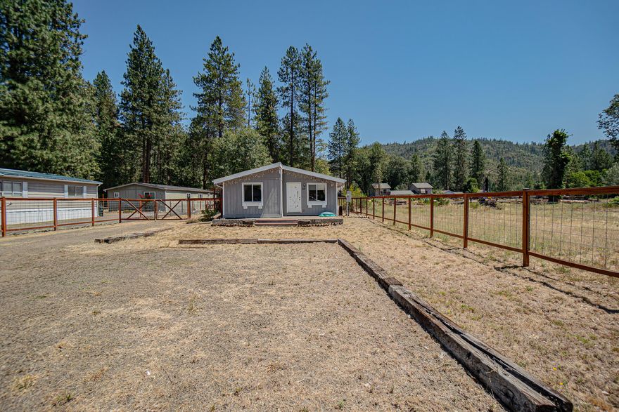 Double wide manufactured home sitting on .32 of an acre just minutes away from the Rogue River. This home features 3 bedrooms, 2 full bathrooms, 1392 sq ft, a spacious living room, stainless steel appliances, granite kitchen counter tops, a bonus room just off the kitchen with a built-in play house, updated hall bathroom and a primary suite with a handicap accessible shower. Property features a covered side porch patio, RV parking, fenced area, storage shed and lots of flat usable space for additional parking, gardening or whatever your needs may be. Home needs a little TLC but has a lot to offer. Close to schools, shopping, recreational activities and much more! Call for a tour today.