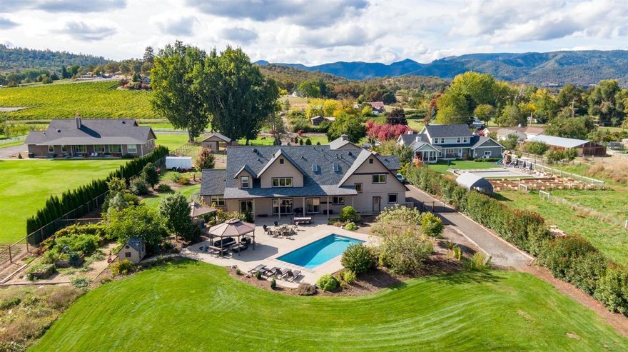 This property literally checks all the boxes: Stunning Craftsmanship, Main Level Master, Manicured 2+ acre parcel w/ irrigation & views. 1200 SF shop for the hobbyist/recreational vehicles, in-ground pool & more! 5 bedrooms + a recreation room and office with a closet (or 6th bdrm). Laundry Rm on each level. Great room has a 20 ft ceiling, a floor to ceiling fireplace w/ rock detailing & exposed beams. Gorgeous main level owner's suite boasts crown molding, spa-like tiled bathroom with oversized shower & two showerheads + an attached office w/ built-ins. Chef's kitchen w/ 6 burner range, dual ovens, copper sink & pot filler. An entertainer's dream; saltwater gunite pool, rustic gas firepit, water features, built in sound & mature landscaping. Detached 1200 SF shop w/ 12-foot doors on both ends, 220V & 30AMP hookups, + a 2 car attached garage w/ shop area. Pasture, small barn, area for chicken, gardens & memories. Gated entry, panoramic views & surrounded by other gorgeous estates.