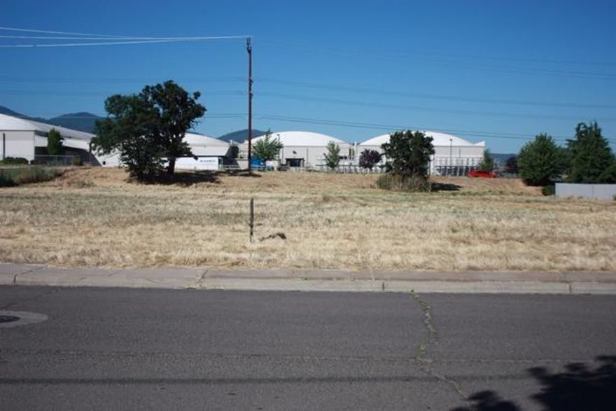 High visibility development lot on HWY 99 and South Stage Rd. High Traffic count. Prime commercial location. In Medford City Limits.