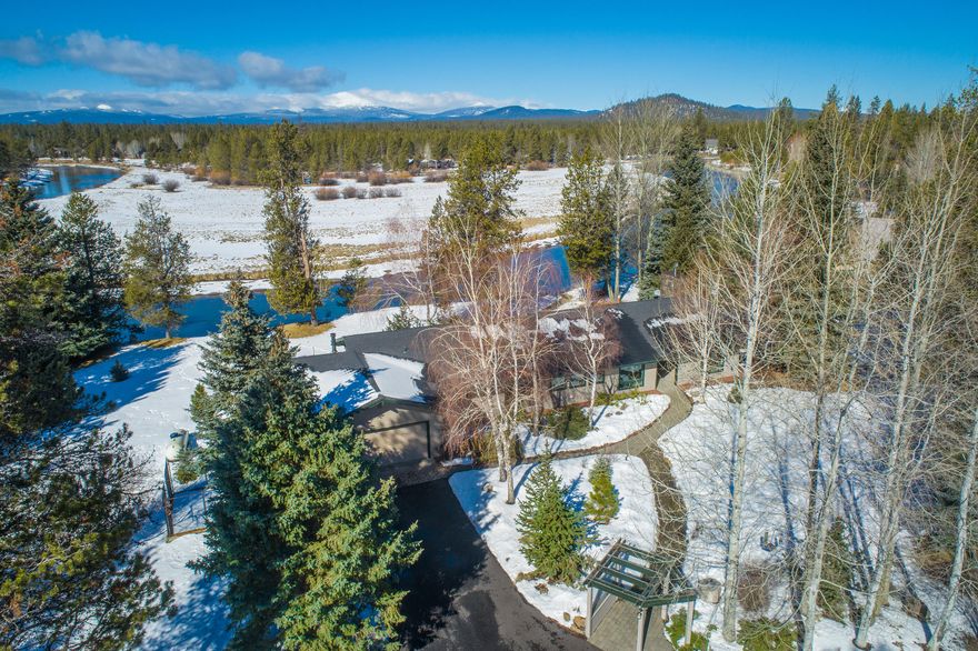 Majestic views of Mt. Bachelor, 215+ feet of river frontage on the Deschutes, a wonderfully private setting, and location within the coveted Gatehouse Lane community define this exceptional Central Oregon property. The single level home is nestled on 3.14 forested, landscaped, and fenced acres and offers nearly 3000 square feet of interior living space. The residence features two bedroom suites, a massive great room, a well-appointed kitchen, an office/den, and flex/guest space.  Vaulted ceilings and huge windows and skylights provide an open feeling, an abundance of natural light, and views from nearly every room. A heated two-car garage is attached to the home. Plenty of additional storage is available in a detached, oversized one-car garage and two large carports. Extensive paver hardscape paths and patio augment the home, and a fixed dock with a kayak/board ramp provides easy access to the river. Just minutes from Sunriver, Mt. Bachelor, and many state/federal rec sites.