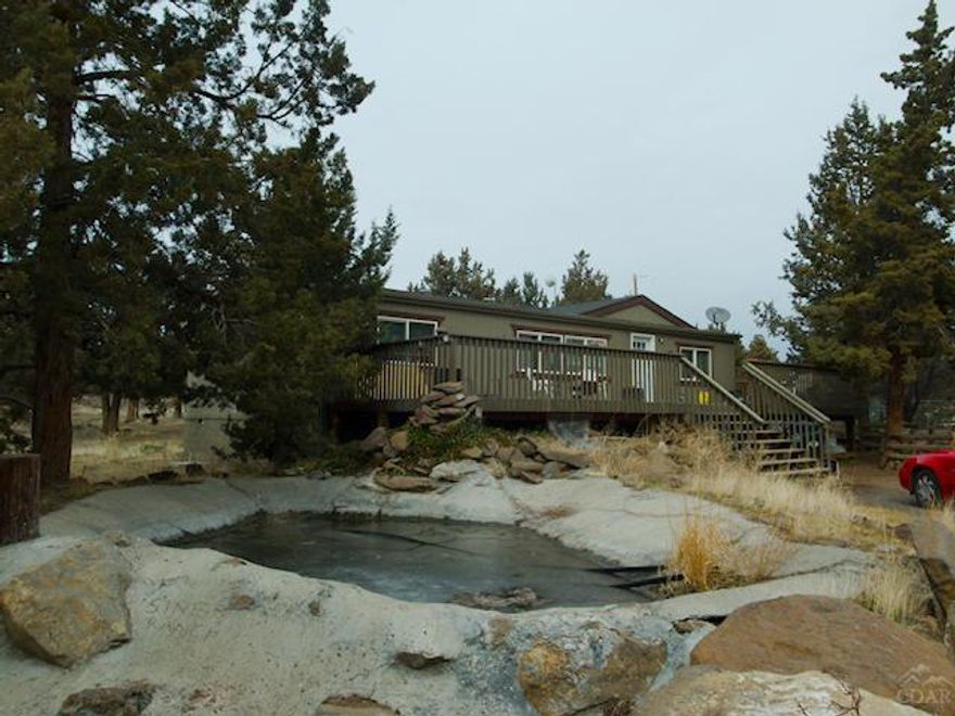 Double-Wide MF Home on 2.47 acre lot! Excellent value! Lot is level and useful. Large deck - peaceful and quiet. Spacious master with walk-in closet. Property is fenced and has water feature in front that needs to be hooked up and storage building. Needs work. Short sale - bank approved price.