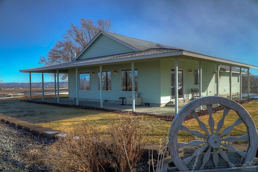 Panoramic views of the Cascade range from the top of the hill in South Madras. Custom built home showcases the mountains by day & the ski bowl at night. Wrap around covered patio, efficient plan w/Great Room feel, open kitchen w/bar seating & lg bedrooms. Finishes include Tumbled Travertine tiled flrs, Hickory bead board cabinets & a full appliance package. Forced Air w/heat pump & a propane fire place in the Great Room. Lg shop/detached garage, loafing sheds & is well setup for 4-H projects or horses.