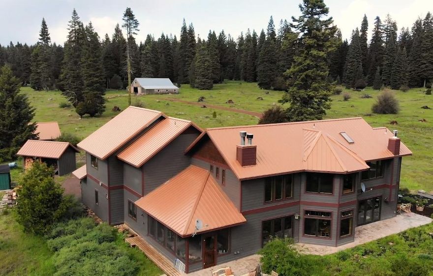 Bask in beauty and privacy at the absolutely spectacular Highland Meadow Ranch. Two off-grid dwellings, 1/2 mile apart, on 160 acres of EFU land with water rights from Grizzly Creek, bordering BLM and teaming with wildlife complete with 2,720 sqft barn, 2 wells, spring-fed pond, marketable timber and incredible views of Mt McLoughlin. Follow easy-care red rock road 1 mile from the road to the main house, built in 2005, which has 3,264 sqft with 3 bedrooms, 3 bathrooms, sunroom, beautiful warm woods (cedar, fir & cherry) throughout, granite countertops, skyline windows with views from every corner, radiant heat, tankless propane water heater, hooked up to quality high-tech off-grid system. 1992 solar-powered log cabin is 1,136 sqft with 1 bedroom, 1.5 bathrooms; RV parking & all hook-ups, separate 25 gpm well; currently registered B&B. Large barn has 15' tall doors, 3 horse stall doors, attached green house and electric hook-up for covered RV parking. 35 minutes to downtown Ashland.