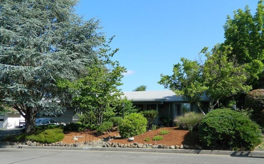 Two bedroom home in NE Grants Pass with lovely landscaping. 2 bdrm, 2 bath home on large city lot. 1458 sqft, large living room, family room with fireplace, oversized kitchen with lots of counter space and cabinets. Master with private bathroom. New hotwater heater, newer heat pump, new kitchen countertops. Cover patio, fenced, double garage, off street parking.