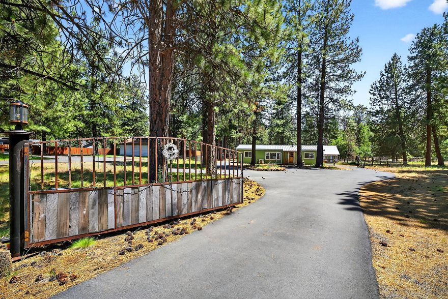 Nicely remodeled 3-bedroom, 2-bath 1986 manufactured home on a spacious 1.24-acre lot. Updates include beautiful hardwood floors and a primary bathroom plus hall bathroom with heated tile floors and tiled walls in shower. The living room features vaulted ceilings, a cozy wood-burning stove and built-in shelving, there's great separation between bedrooms for added privacy. An additional sunny bonus room off the kitchen offers flexible space for a home office, playroom, or hobby area. Enjoy the outdoors in the large, private back deck complete with a hot tub and sprinkler system. The fully fenced and cross-fenced property includes RV power and water hookups, a stubbed valve box for front yard sprinklers, and a fully paved driveway with easy access to both Brookswood Blvd and Hwy 97. A large shop and greenhouse complete this beautiful property.