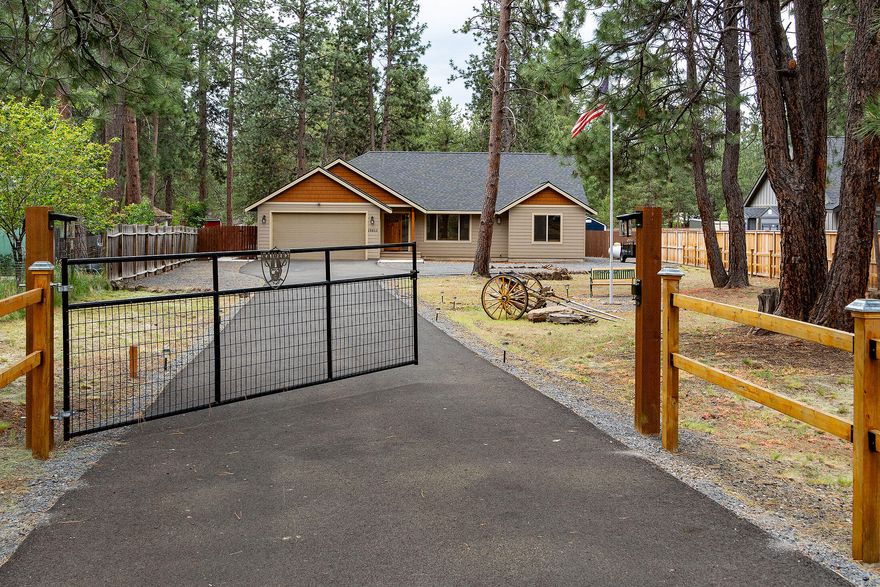 Appraised at $835K, 8/2025! Stunning 2019, 3-bedroom, 2-bathroom single-level home on 1.20 acres, features a spacious great room floorplan & high-end finishes throughout. Enjoy solid wood doors, wood-wrapped windows, plantation shutters, custom hickory cabinetry, soft-close drawers & solid surface counters. The heart of the home boasts a floor-to-ceiling stone fireplace, vaulted ceilings, exposed wood beam, and a large kitchen island with breakfast bar, stainless steel appliances & pantry. Spacious primary suite offers excellent separation from guest rooms, a large walk-in closet, & en suite bath w/double vanity & tiled shower. Step outside to relax on the expansive concrete patio, complete w/solar-operated, waterproof cover. Fully fenced w/gate, a well-designed shed, & ample parking for trailers & toys. Located in the sought-after Caldera High School area! Only 5 min. to town / 30 min. to Mt. Bachelor! A rare blend of privacy, style & convenience! Located in the county - no city taxe