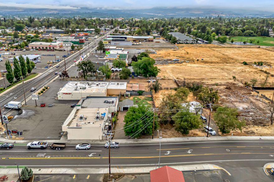 Vintage fixer-upper on a large 0.19-acre lot with excellent development potential for high-density residential and mixed-use commercial, centrally located in SW Medford near groceries, shopping, restaurants, and schools. Survey recorded with Jackson County shows ~57.89' of frontage on Lozier Lane with total lot area of 8,343 SqFt. Home is set back ~30.8' from Lozier Lane with 1,120 SqFt of living area, two bedrooms, one full bathroom with tub shower, original hardwood floors, natural gas furnace, living room, kitchen, laundry mudroom with utility sink and door to covered backyard patio, and detached 384 SqFt garage with concrete slab foundation. Front yard with mature tree, roses, gravel parking area, and concrete driveway with ample space for RV parking. Property shall be sold ''As-Is'' in present condition. Inquire with agents to access additional documentation and details!