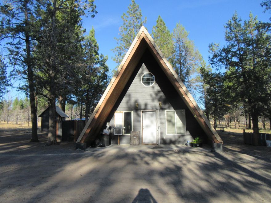 Cute 2 bedroom 1 bathroom  A-frame home on 20 acres in wonderful forested setting1with detached garage, very nice Insulated well house with laundry hookups. Chicken house enclosure and another shed.  Ownership to 1/49tj interest subdivision  lake! Seller will give a credit of $5000.00 at closing to the buyer if the seller receives an offer no later than 9/29/25 and closing within 30 days or less of accepted offer.