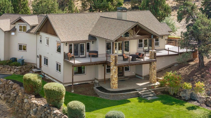 Enjoy awe-inspiring panoramic Cascade Mountains and Smith Rock vistas from virtually every room in this exceptional Northwest craftsman home, nestled near Tumalo. Situated on three private acres, the property borders 120 acres of public land. This meticulously crafted retreat encompasses five bedrooms, four full bathrooms, and a media/family room with a wet bar and double-door access to a generous patio and yard. Additional amenities include a wine cellar, multiple outdoor living spaces, and an expansive covered deck for year-round entertaining. An oversized three-car garage, a 1200-square-foot detached shop with power and water, and an RV parking spot with full hookups complete the property.