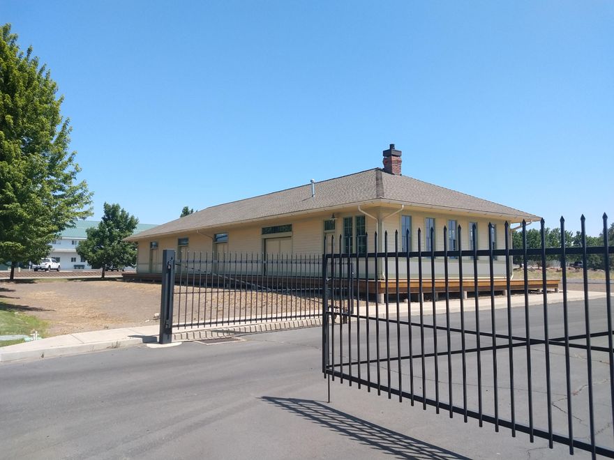 Owner user or income investment for this Historic Redmond Building with excess land ($300,000 value) for an additional building.  The Historic Oregon Trunk Freight Depot was successfully moved to this location in 2004 & completely upgraded while preserving Ifs historic significance. This unique building is the perfect multiple use building with many potential uses allowed in M2 Zoning. Front office is 360 sq ft. open office/warehouse area with cubicle panels is 2,640 sq ft., 2 bathrooms & many historic features. Extremely well constructed building that has been lovingly restored by the Owners. This building is well located on a level corner Industrial parcel with ample room to build an additional building with parking & storage. All utilities are located on site with power vault (3 Phase), sewer/water/gas/cable, sidewalks & 2 metal entry gates. Full marketing brochure is available.