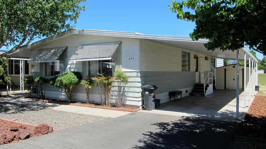 AFFORDABLY PRICED to add your own personal touches! Larger unit at 1440 sq.ft., 2 bedrooms, 2 full baths. Formal living & dining area, large TV room adjacent to the kitchen. Covered front porch with two 8x10 sheds for extra storage. Carpet recently cleaned and in good condition. 2-car tandem covered carport. All appliances included. Come and see this home in the desirable Rogue Lea Estates right next to the Rogue River and just minutes from downtown historic Grants Pass. Any buyer needs to be approved by the Park (an easy process)!