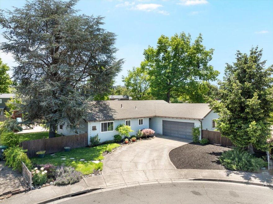 Tucked away on a quiet cul-de-sac in an amazing school district, this beautifully updated single-level 3 bed, 2 bath home offers comfort, space, and convenience. Recent upgrades include a newer HVAC unit (Sept 2021), Energy Star rated double-pane windows and sliding glass doors with a transferable warranty through DaBella, and a new stovetop (Dec 2024). Owned solar panels provide energy savings and peace of mind. The large, fully fenced yard features lush landscaping, an irrigation system, mature fruit trees (apple, cherry, nectarine), Maple and Red Oak trees for summer shade, raised garden beds, and a children's play structure. A walking path behind the home leads to a peaceful creek—perfect for relaxing walks. Located near a hospital, parks, and amenities, this home blends privacy and accessibility. A true gem!