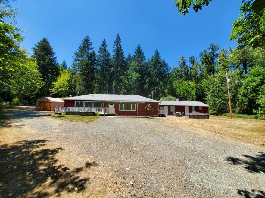 Nicely updated, Single level. Newer Roof, 3 bd/3 bath. Wheelchair accessible. Newer stainless steel appliances & cabinets in kitchen. Peaceful & secluded  w/a seasonal creek. Spilt floorplan w/2 bds w/walk in closets adjoin a bathroom w/a walk in shower. Another bathroom w/a walk in shower & lrg laundry rm w/sink. On the other side,1 bed w/detached full bath & kitchen.  Long hallway in the front of the home. Great for plants to blossom. Covered patio in back & in front & a detached bldg (approximately 600 sq. ft.)that is being used as a shop & storage area. Possibility of turning it into an ADU. So many potential uses for this property. There are 4 Tax lots. Seller believes they can be sold separately & lots have the potential of being divided into smaller lots. Buyer to do their own due diligence on property uses. Glendale has a bank, market, places to eat, a theatrical theater, hardware store, Medical, therapy and dental facilities. High Speed Internet. Security Cameras