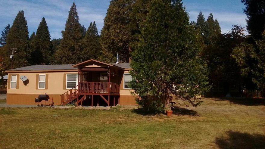 Only 24 minutes from Grants Pass, this home and property has been so well maintained it looks new. Kitchen design is French white with a portable island that you will love cooking in. Spacious bedrooms, with spacious closets and a large master bathroom with a separate bath and shower. Breezeway between the garage and back door as well as a deck off the front door which leads to a well manicured yard which is fenced. All this and Wolf Creek borders this property. All furniture and Tractor are available for sale as moving out of state.