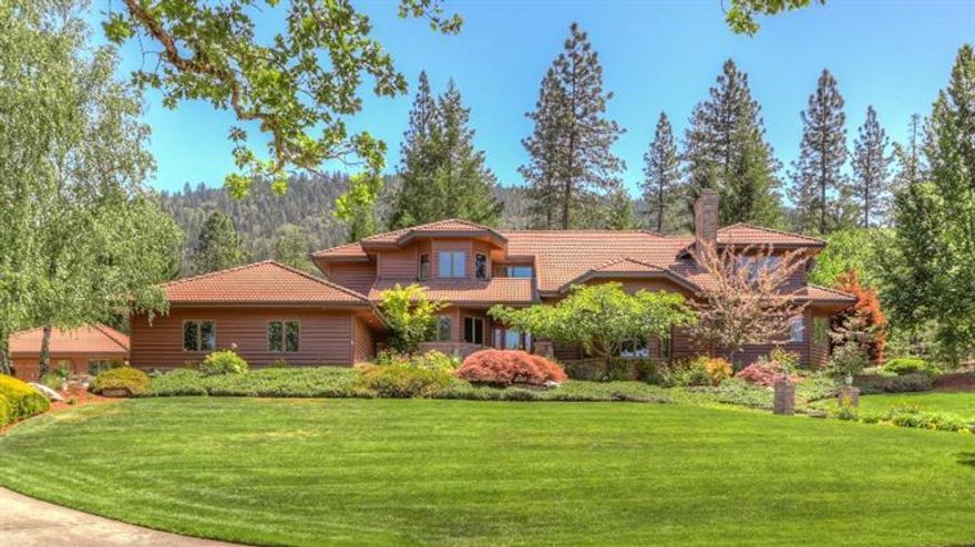 This Stunning Serenity Lane masterpiece is the home you've been waiting for. A gorgeous custom estate featuring 4 bedrooms, 5 baths in 5932 sf has been extensively remodeled. The cook in your home will love the gourmet kitchen with granite counters; pantry; large island; and newer appliances. Dine in your formal dining room; kitchen nook; or enjoy a snack at the counter. Amazing vaulted cedar ceiling in the family room with wood stove and brick hearth; crown molding throughout; and views from every window! The master suite is your spa getaway with soaking tub; oversized shower; sitting area; walk-in closet and just outside a hydrotherapy spa. Sunken living room with fireplace; game room & bar; office with built-ins; beautiful wood floors and central vac. Attached 2+car garage; detached 24x24 shop; wine cellar; & so much more. The estate grounds are gorgeous with mature landscaping; in-ground pool; paved driveway and security gate all on 6.41 park-like acres. Welcome home!