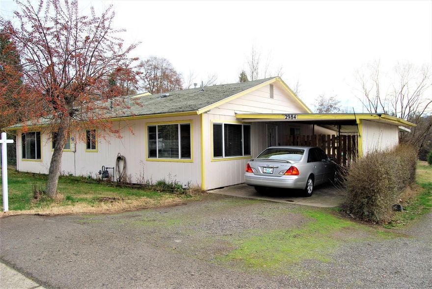 Extra large lot in desirable East Medford location. Detached shop and covered RV parking come with a 3 bedroom 2 bath home with open kitchen area, living and family room. Plus an extra room that could be used as an office. Great potential for the price.