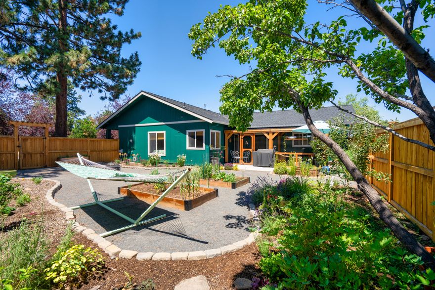 Light, bright, and beautifully updated, this single-level 3 bed, 2 bath home in a quiet, established SE Bend neighborhood is truly move-in ready. Situated on a spacious .20-acre corner lot, the home features recent upgrades throughout—including a new roof, HVAC, A/C, laminate flooring (no carpet), new appliances, and fresh interior/exterior paint. The fully fenced yard is a landscaped oasis with mature trees, and a custom-built catio! There is also a welcoming front porch. Inside, enjoy open living, generous natural light, and a cozy yet modern feel. You may occasionally hear the gentle hum of a nearby train—no whistles, just a soft reminder of Bend's charm and connectivity, and the wall between the property and tracks does a great job to mitigate noise. A 2-car garage includes pull-down attic storage, and the lot offers rare RV parking. Located just minutes from parks, schools, and local trails—this home blends comfort, functionality, and charm in one incredible package.