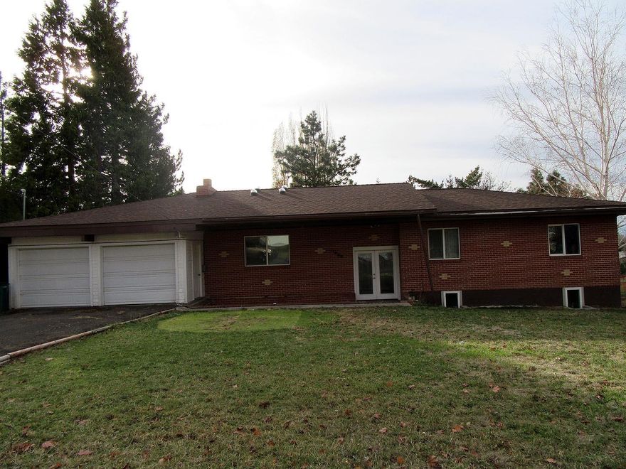 Large brick home built in 1963, featuring 4 bedrooms and possibly a 5th bedroom with an exterior door, plus a big office area. 2 full bath rooms, plus utility room. Living room with wood fireplace, dining room open to the kitchen with breakfast bar and pantry, gas heat. Huge family room with pellet stove down stairs. Tons of storage, plus 2 car garage with work shop area/man cave. .27 acre, big corner lot, lots of RV parking, deck, and a fenced back yard. Only $78.50 per square foot. If you need a big home in a great area, this home is for you!