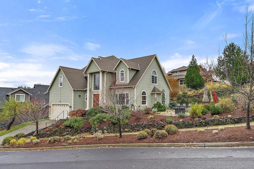 Beautifully designed to capture views of the vast mountain range and valley, this 4 bedroom 2.5 bath home is spacious and elegant. Impeccably maintained and filled with natural light this home offers it all. Soaring ceilings invite you into the living room where a gorgeous slate gas fireplace awaits. The kitchen boasts slab granite counters, stainless steel appliances and access to the private backyard and gardens. The Main level master invites ease of living w/ a dual vanity and jetted bathtub for soaking. Upstairs you will find another master w/2 additional large bedrooms. The upstairs master has an added sitting room w/ large arched windows framing the Cascade Mountains and Grizzly Peak. The outside gardens are fully landscaped w/timed irrigation & solar lights guiding you along the stamped concrete pathway to the many sitting/eating areas, each selected to artfully take in the views. A deer proofed rose garden and gas fire pit complete the outdoor ambiance. Attached two car garage.