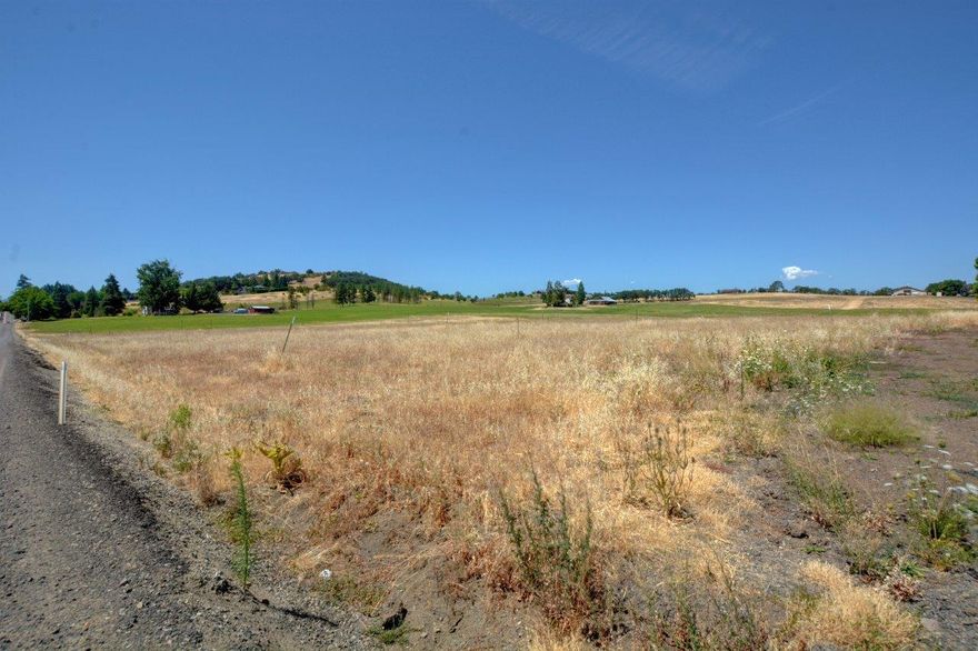 Large .31-acre lot at the edge of the Urban Reserve Boundary.  Prep work has been done to lot already and the road approach permit has been approved and work completed.  Address has been assigned, and DEQ permits have been paid for.  When buyer naturalizes the dirt, all that will be needed is an inspection.  Full set of engineered house plans come with the lot.  Plan review fees have been paid as well.   Uniquely located with great views with shopping and schools close by.