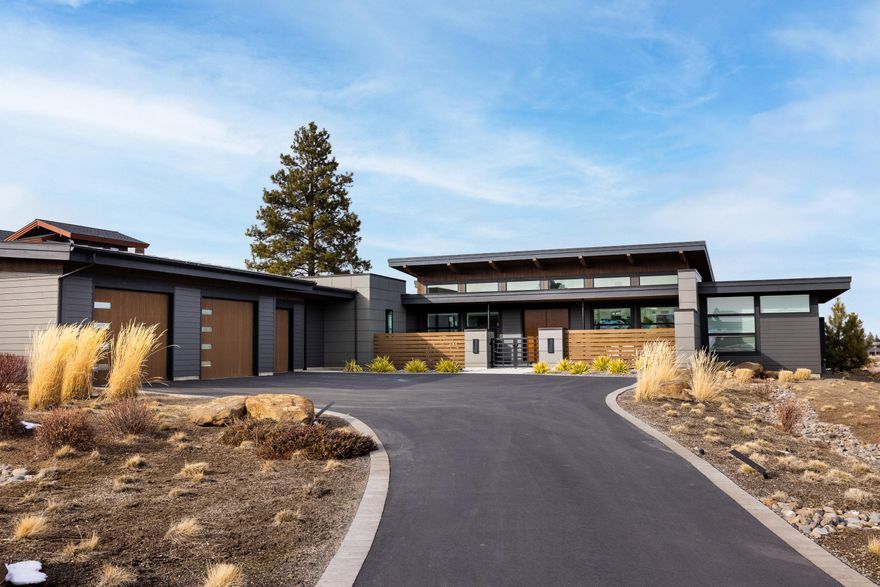 Simply Stunning. This artisanal modern design was skillfully crafted by Timberline Construction. Located in Tetherow on the golf course with fairway and some mountain views. The gated courtyard leads to a welcoming double door entry and the perfect single level floorplan with walls of windows bringing in abundant natural light. Beautiful large kitchen with eating island and sleek white cabinetry is open to the great room with fireplace & soaring ceiling, custom glass wine cellar is the masterpiece that anchors the dining room with a built-in serving buffet. Privacy and separation with the master suite and two guest rooms on opposite ends of the home Features include wood floors, solid surface countertops, artful light fixtures, office with built-in desk overlooking the fairway green, outdoor patio eating area w/built-in BBQ, built-in radiant ceiling heaters, in-ground hot tub, and huge 1515 sq ft garage with an enclosed area for an exercise room or could be finished for other use.