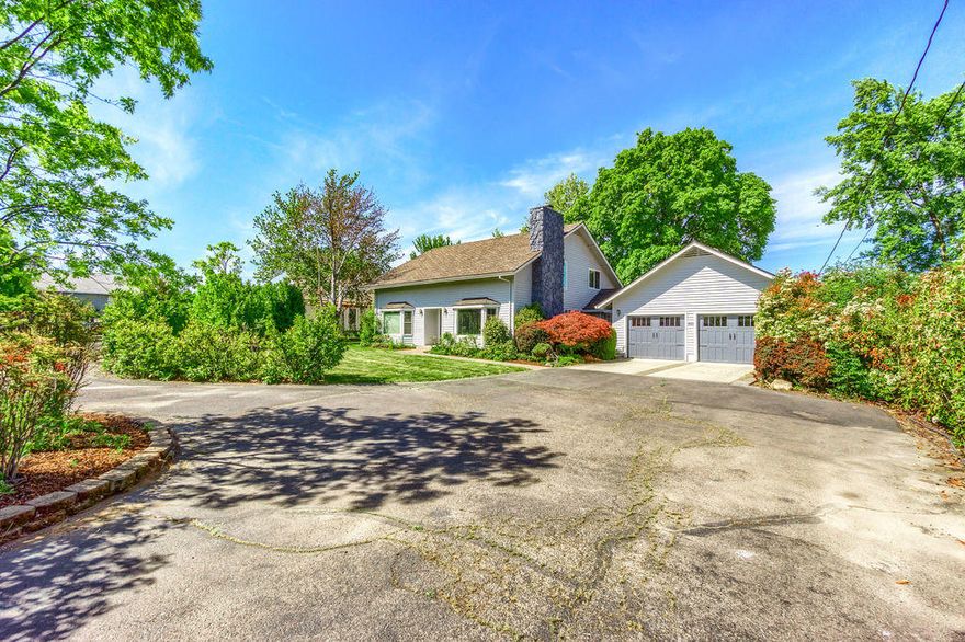 Have you been searching for a home with a little elbow room and a shop for all your toys but want to stay in town? Your search may be over! This spacious 4 bedroom 2 ½ bath home sits on over half an acre, features a 26'x50' shop & so much more! Updated home has a sunken living room w/fireplace. Kitchen features granite tile counters, stainless appliances, gas cooktop & white cabinetry. Family room has eating area, fireplace, adjacent half bath & slider to the backyard. Main bedroom is on the 1st level, has an on suite bath w/dual vanities & tile shower. Upstairs you will find a spacious bonus room, 2 large bedrooms w/vaulted ceilings, nice sized 3rd guest room & full bath. Insulated 2 car attached garage w/new garage doors. Shop is insulated & has 20'x26' storage in attic, plus attached carport on one side & pergola on the other. Peaceful backyard is a lovely place to BBQ or just relax. Home has vinyl windows, lifetime roof installed around 2005 & exterior was painted 2 years ago.