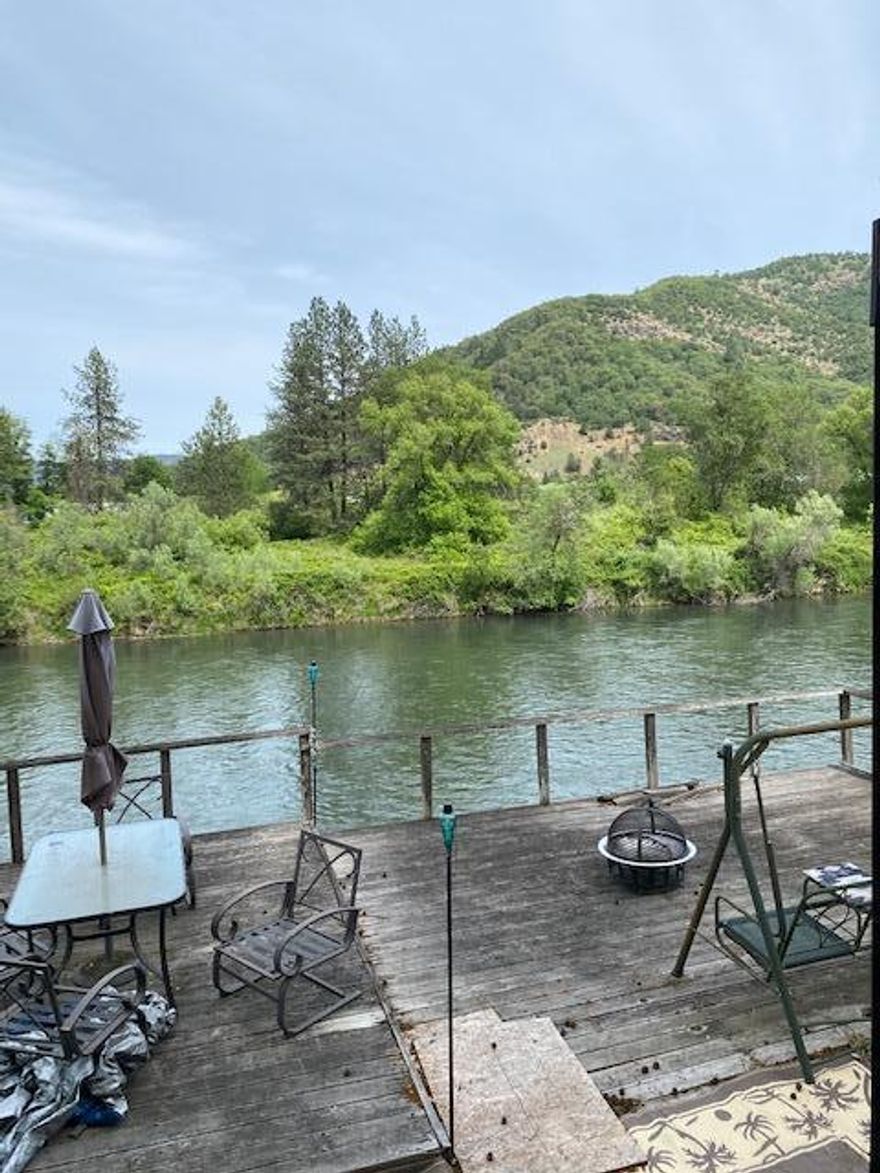 FISH THE ROGUE from your .13ac recreational lot right on the Rogue River close to the town of Rogue River. State Park land across the River. Existing septic system is legal. Includes 2500gal water holding tank($95 to fill & lasts 4-6 mos) and 2017 one bedroom Sandpiper RV/MH (Model 377 Flick), which cost over $70,000 two years ago. This tiny home has a desirable spacious flow and finishing details, giving a feeling of rooms & providing supreme comfort with approx. 320sf before adding the extra space afforded by the 5 slide-outs. Features include one large bedroom & bath, a spacious kitchen w/full-sized refrigerator, range/oven, built-in microwave, XL pantry, central vac system, electric fireplace, tv & lush recliners & couches in living room, washer/dryer hookups for RV-sized appliances, surround-sound system for music & tons of storage throughout. Deck overlooking River may need some repair. Floodway, buyer to do own due diligence w/FEMA for any potential building, or other uses.