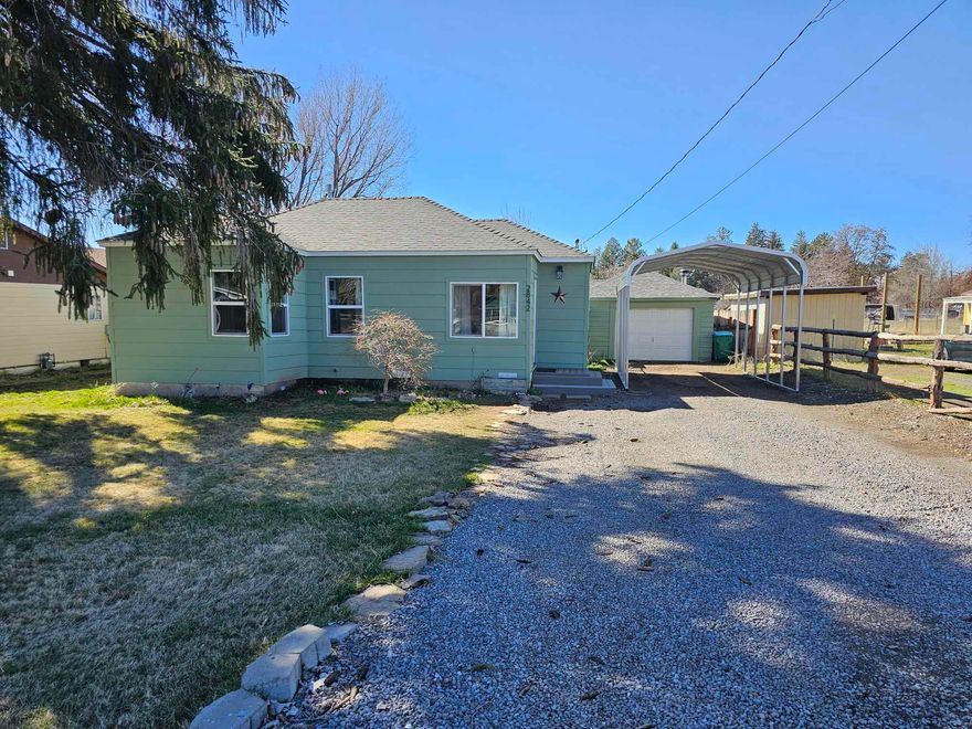 Adorable and affordable! This charming 2 bed 1 bath cottage sits on a large city lot with plenty of parking and room to entertain! There is something here for everyone including a detached garage, workshop, storage shed, carport, RV parking with electrical hookup and dump station-- as well as a fenced garden with raised beds, pergola, and BBQ area. Loads of modern updates include a new roof, siding, windows, doors, AC, and flooring throughout. The newly remodeled interior features a completely updated kitchen with new cabinets, tile, sinks, range, and refrigerator. This home is ready for its new resident!  Don't miss it!