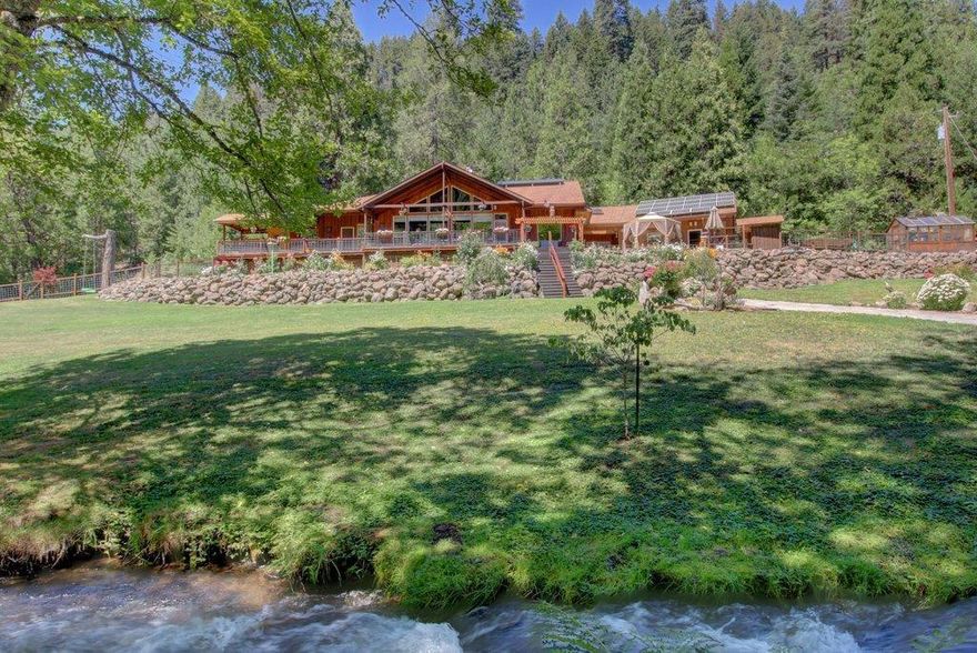 Let the tranquil sounds of the creek wash away your worries on this private retreat! Located on North Fork Little Butte Creek, this one of a kind home will mesmerize you with its natural beauty. This private mountain paradise sits on 7.21 acres acres and features its own island! The home welcomes you into its arms with a full bounty of natural light and spectacular views. Alder wood flooring & a custom built entertainment center pulls you in and beautifully accents the Tulikivi Soapstone Fireplace that will keep you cozy during the winter! The master bedroom is spacious and lends incredible views of the creek and surrounding mountains. The master also has a walk-in closet, large soaker tub, dual sinks & a walkout to the covered deck, equipped with hot tub & dry sauna. A private bridge crosses the creek that leads you to your own private island. The property also features a covered RV pad with electric hookups, detached 2 car garage, greenhouse, chicken coup and more!
