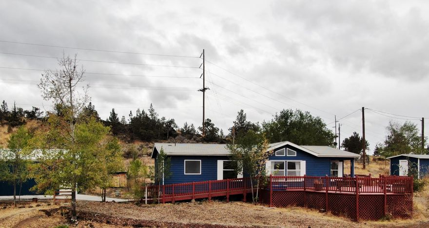 Great Opportunity! Own a move-in ready home on 2 acres with privacy and gorgeous views of Smith Rock. Home has been
completely updated with laminate & tile floors, propane stove in living room, and much more. Enjoy our beautiful Fall weather from the spacious deck or around the firepit on the patio. Property is partly fenced, has a 3 stall loafing shed, poultry coop, insulated
pump house, & garden shed. The detached double car garage is oversized with a shop and skylights. ADA wheelchair ramp for access to home.