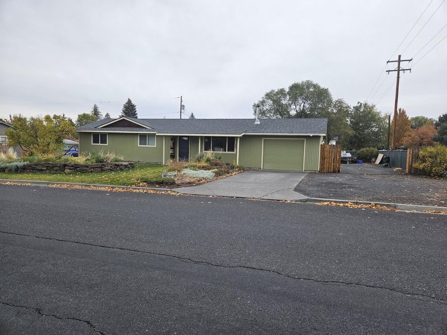 Great Location! This home is situated on a corner lot on SW Canyon Drive! Newer laminate flooring and updated kitchen and bathrooms! The backyard is fully fenced with a covered patio which is perfect for gatherings or just relaxing! Storage shed and also 2 gates that are perfect for RV/Parking area!  There is access to Redmond's Dry Canyon right across the street! Very Convenient location near schools, parks and shopping!