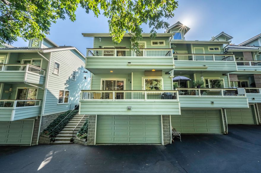 Overlooking Clay Creek, this light-filled townhome features solid oak flooring, soaring vaulted ceilings, two spacious bedrooms with full ensuite bathrooms, as well as a lower-level office. The kitchen has a granite island with dining bar,  garden window, GE Profile four-burner gas range, dishwasher, and refrigerator; adjacent dining area with built-in cabinetry and balcony access. The master suite is outfitted with a walk-in closet, dual vanity, and romantic view balcony. Other amenities include top-down/bottom-up blinds, living room with gas fireplace and charming bay window, main-level half bath, and two-car garage. HOA dues cover exterior maintenance, landscaping of common areas and open space, along with trash and recycling service. Centrally located within 3 minutes of grocery shopping at Market of Choice!