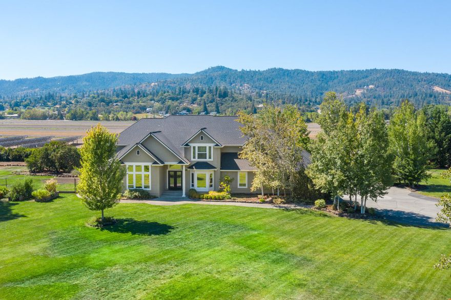 Horse enthusiasts this could be your new home! 21.5 acres of flat, usable land with irrigated pastures, 2 riding arenas, and an insulated and heated barn with 3 stalls and runs. Located in beautiful Southern Oregon minutes to town, medical and airport. The home is a magnificent 2006 built, 4 bedroom 5 bath, 3,800 sq.ft. delight with 25' soaring ceilings in great room. The island kitchen is a chef's playground with extensive granite counters, an abundance of cabinetry, high-end appliances and a huge walk-in pantry. The main floor master is very spacious with lovely built-ins; the bath has dbl. vanities with travertine floors & counters, lg. 3 head walk-in shower and closet. 3 bedrooms upstairs with 2 having en-suite bathrooms. There is a detached, heated 2 car garage with a 1 bedroom 768 sf. apartment. Huge covered RV pkg. & hay storage area. The yards are expansive and connected to irrigation. Out back is a fabulous covered patio with a nearby koi pond & 2 waterfalls. Call Today!