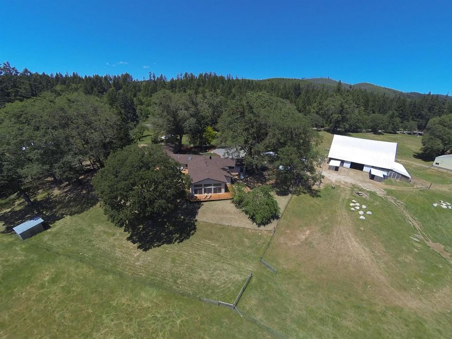 Welcome to the historic Deer Creek Rd Ranch. Situated on nearly 100 irrigated acres, this gorgeous property boast a custom 4,000+ sq. ft. home plus an 1850 sq. ft. second legal dwelling. The main home has 4 bed 3 bath (which includes a mother-in-law suite with it's own kitchen, bed and bath, entrance), a chef's dream kitchen with stainless appliances (Wolf cook top) and huge island, large master with spa-like bath and massive walk in closet, 2 separate living areas, formal dining and expansive 360 degree views! There is also a large 2000 enclosed rec. room. The 3/2 ADU is located far enough away for complete privacy. The completely irrigated property has 5 groundwater sumps, each with power and pumps. The historic barn is over 100 years old and is approx 5,000 sq. ft. There is an additional 6,000 sq. ft. of storage space between 2 huge shops. This amazing property has two creeks, abundant wildlife and is completely fenced. Way too much to list. This is truly a must see property!