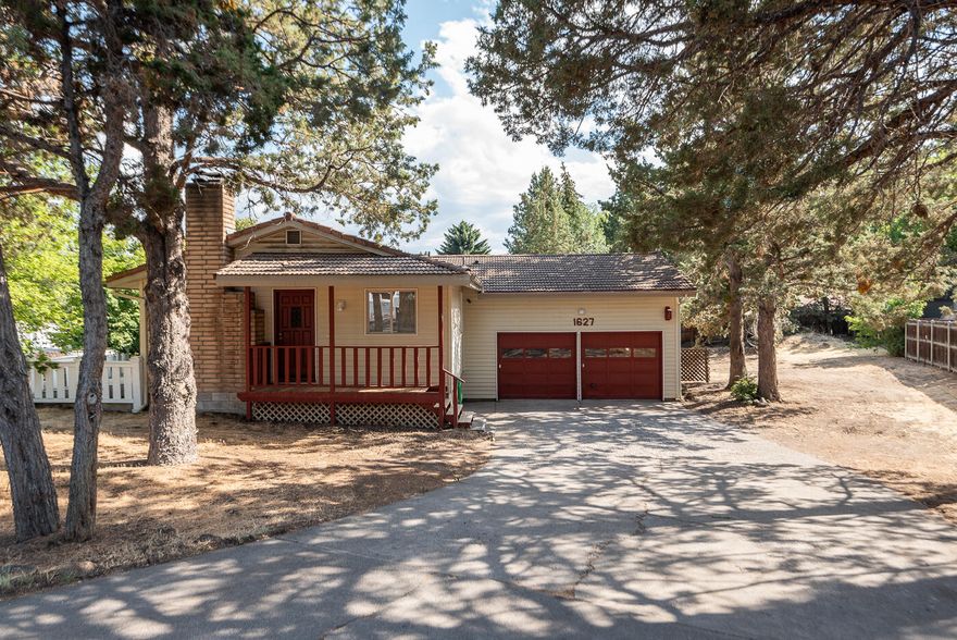 Immagine the possibilities here!  Spacious home with an open great room design, downstairs family room, 2 beds 1 bath on each level, an oversized garage and a spacious .26 acre lot with room for RV!  Enormous potential for a multi-generation living or multiple roommate rental setting.  The home is a blank canvas for your own vision and approach, with solid bones & a tile roof.  A great close in location with easy access to all of the routes around town!  Offers a great view of Pilot Butte, southern exposure for your garden, a lava rock fireplace upstairs & a woodstove downstairs.  Newer cable wiring in summer 2013.  Shop area in the garage & lots of storage. MOTIVATED SELLER! All reasonable offers considered.