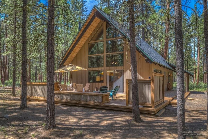 Escape to this rustic chalet style cabin bordering US National Forest, ideally located on a quiet lane near the Big Meadow Golf Center and close to the Main Lodge Recreational Complex. Open great room floor plan with vaulted open beamed ceilings, pine paneling and a cozy wood burning stove. Interior offers 4 bedrooms, 2 baths and a loft with south facing window wall that opens to a large deck and seating area. Hot tub off rear deck overlooks the National Forest setting. Detached garage/carport.