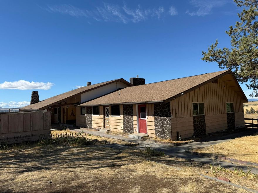 Views of Mt Jefferson from the Great Room, custom vaulted ceilings with extensive exposed wood beams, gas fireplace, rustic rock work, built in bar space, in ground pool and irrigation water. Windows have recently been replaced. Update this beautiful home or keep its unique ambiance. Barn with a couple stalls already in place. Space available to build additional shop.  Irrigation equipment onsite included in unknown condition. Buyer to do their own due diligence on all aspects of the property. Property is being sold in as-is condition.
