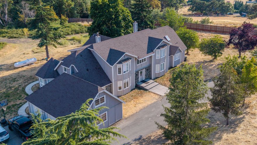 Now Priced to Sell! Discover this stunning 5,123 sq ft contemporary retreat in the peaceful community of Williams, OR. Tucked away in the scenic Applegate Valley, this spacious home offers a tranquil lifestyle with endless potential. The main level features a large primary suite with a sunroom, a brand-new kitchen, dining nook, and an office. Upstairs, you'll find a full entertainment area with two bedrooms connected by a Jack and Jill bathroom, an additional bedroom suite, a hidden bonus room, and a second living room with a balcony showcasing breathtaking mountain views. The property also includes a 100x50 shop with concrete flooring, roll-up doors, insulation, and power—perfect for home-based work or hobbies—plus two greenhouses and 10 acres of water rights. Well produces an average of 14 GPM, reaching up to 18 GPM. Ready to relocate to Southern Oregon—schedule your private tour today!