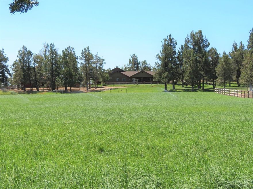 Beautiful Custom Home in a very peaceful and private setting. 9.18 acres with 9 acres of gravity flow water rights. Craftsman style home features a relaxing Koi pond with bridge leading up to the large entry way, 3-bedrooms, 2.5 baths, living room, large dining room, and office. Bamboo flooring and custom wood accents throughout. Very large bonus room over the 3 car garage that affords beautiful views of the 3 Sisters. Large shop. Horse barn with 4 stalls, tack room and large grooming area and hay storage. Large lean-to for hay storage, 90 x 160 outdoor arena. Custom built adorable Greenhouse too. Beautifully landscaped! This is a Perfect Horse Property where the owners have maintained a very successful horse boarding business. Property is fenced and cross fenced into 2 separate pastures, 2 separate dry-lots, and hay field. EVERYTHING IS TURN-KEY.