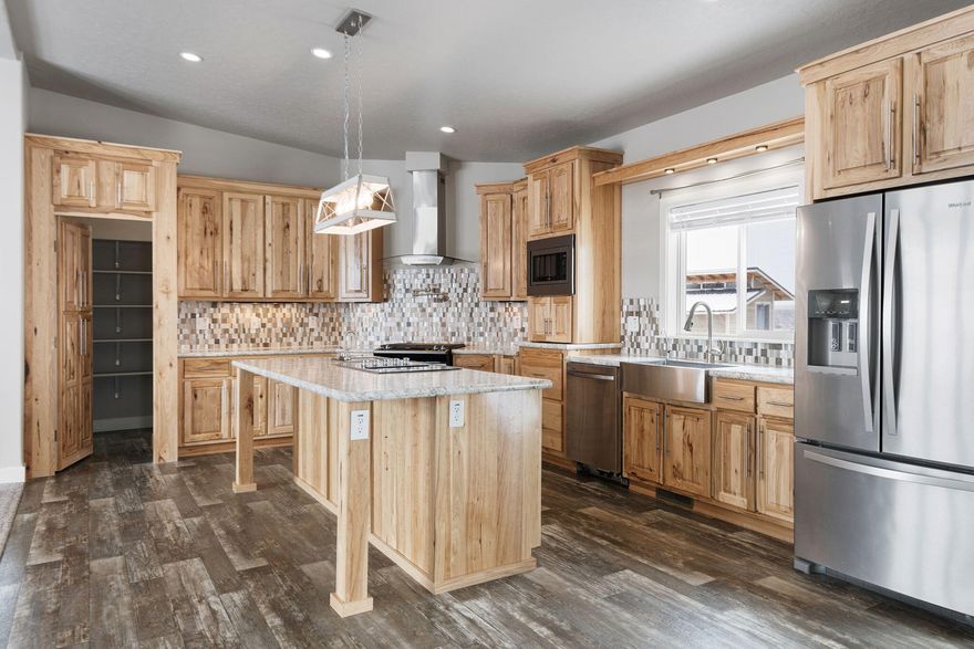 Nearly 20 acre property with mountain and valley views! The bright and roomy layout of this ''like new'' 2020 Champion Home home will impress! 4 bedrooms plus  den! Open concept Kitchen with hidden walk in pantry, S/S appliances, hickory cabinets, water spout over gas stove and an electric cooktop with downdraft on the giant island. Open concept, cozy certified woodstove, ceiling fans and so many windows! Primary Suite separation from guest bedrooms. It features a walk in closet, lighted vanity mirrors, deluxe shower. Overlook the hilly landscape from the soaking tub. The 4th bedroom has both exterior and guest bathroom access. Generously sized den would make a terrific office, art studio or homeschool classroom. Extra sink, full size refrigerator in laundry/mud room. Perimeter block foundation on a slab with seismic ''tie down'' straps. The pump house is heated, has a deluxe water filtration system and storage. Loafing shed and woodshed with room to build your dream shop!