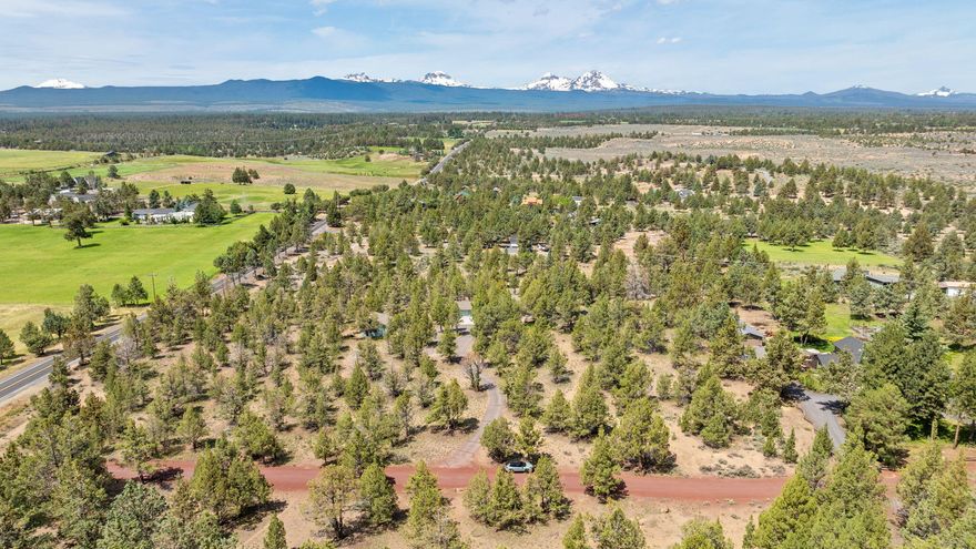 Discover this beautifully maintained 3-bedroom, 2-bath ranch-style retreat on 5 private, usable acres in the heart of Tumalo—just minutes from Bend. Bask in sweeping Cascade Mountain views as you envision the endless possibilities this property offers, from creating a dream homestead to expanding with your personal touch. Inside, the home features two generous living areas, perfect for cozy family nights or effortless entertaining. A spacious attached two-car garage adds everyday convenience, while the detached two-bay shop is ideal for hobbies, storage, or workspace. Enjoy the best of both worlds: peaceful rural living with quick access to Tumalo State Park, the Deschutes River, The Bite, Shevlin Park, Tumalo Reservoir, and vibrant downtown Bend. With single-level living, room to grow, and unbeatable scenery, this property is a rare blend of comfort, potential, and location—ready to bring your Central Oregon lifestyle dreams to life.