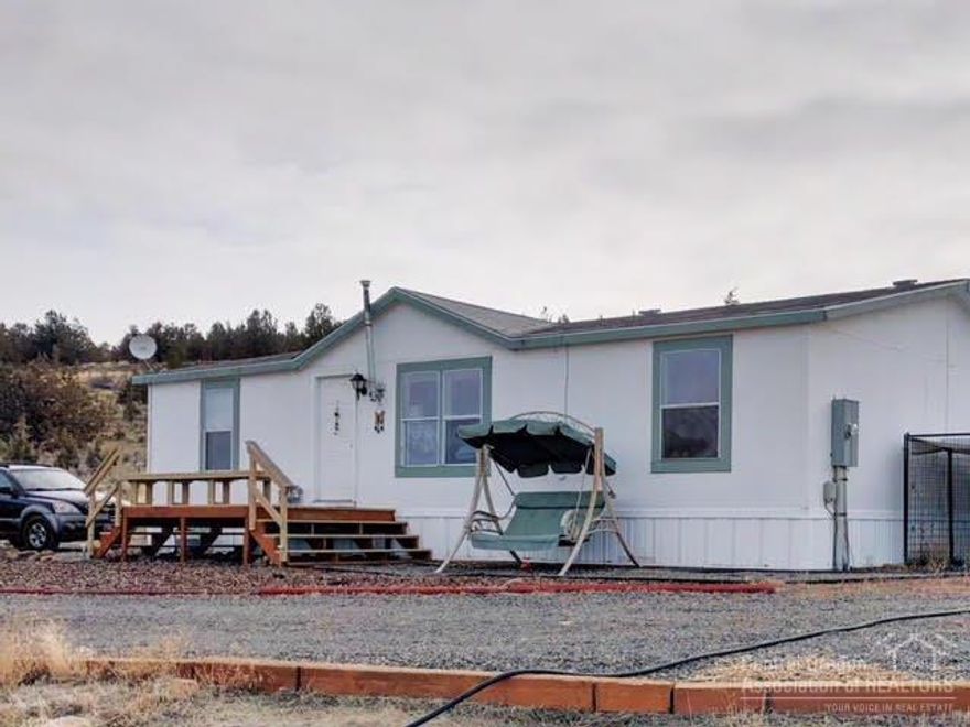 Rural setting on 5.87 acres with amazing views. Perfect horse property with fencing in place, loafing sheds and an arena. Enjoy this country setting with 1188 sqft., 3 bedrooms 2 bath home with a vaulted ceiling in the living room and kitchen. Don't miss out, this wont last long. Seller has a 3000 gallon cistern that is filled up every two month from Bend Water Hauling for $185/fill up. Seller also has a 1500 gallon storage holding tank for water for emergency backup.