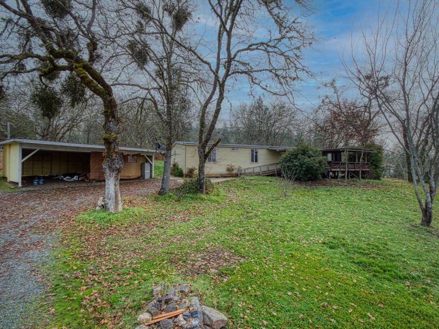 Open House 1/23/2022 from 11-2pm. Potential Abounds! This 4 bedroom, 2 bath manufactured home sits on 6.35 private, wooded, & fenced acres of land with room for animals, toys, projects & equipment. Main house features an extra-large living room and a large kitchen. Detached large garage/workshop + living space with a full bathroom + kitchenette on the second story. Man made Pond  is begging for Koi! Yurt Included in sale. Backs up up to publicly owned land on two sides.