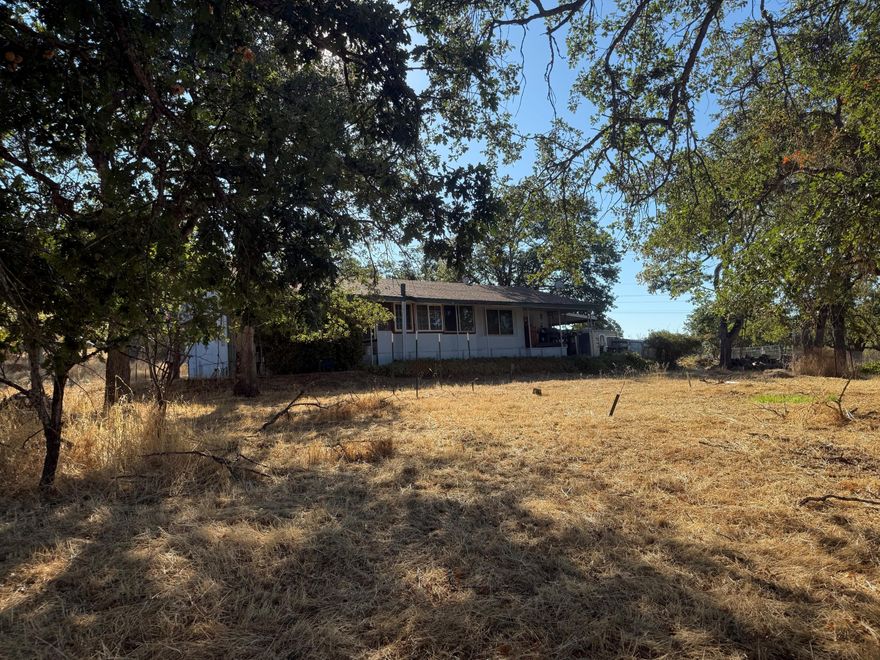 Small acreage perfect for your new home offering a fantastic location, pasture ground and mature shade trees.  2.18 acres with an older mobile home so it does need to be a cash transaction.  Septic does need work on the drain field.  Currently there are two wells on the property, and one does need some work.  This is an as-is sale but offers an opportunity for a great building site.  Buyers to complete their own due diligence in all aspects of the property.  Assessor has square footage at 768, but with add-on's there is more room in the current mobile.