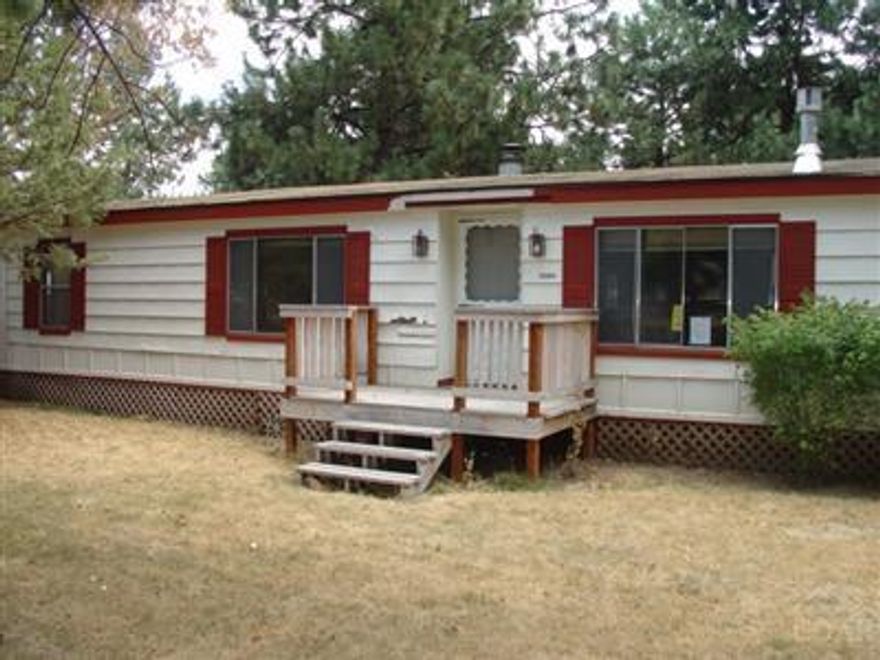 Nice manufactured home nestled in the ponderosas in a quiet part of Sisters close to the heart of town. Recently painted & carpeted, 2 car detached garage, shop area or office, covered storage area, wood burning FP in living rm and propane stove in family rm. Located on a corner lot, nice sized yard. Flrs are carpet & vinyl throughout. Buyer to verify all information.