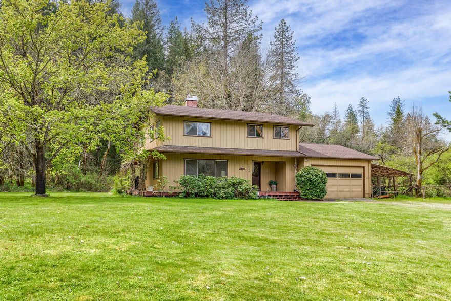 Beautiful property on Evans Creek with irrigation rights!  This well maintained home features a spacious living room opening into a dining area with deck just out the sliding doors and sweet kitchen with pantry.  Upstairs you will find the Master Suite, another large bedroom, full bathroom and expansive office space with additional room previously used as a dark room and private deck looking over the gorgeous back yard.  Covered RV parking attached to a shop/storage area, fruit trees, huge yard and forest behind - this property has it all!