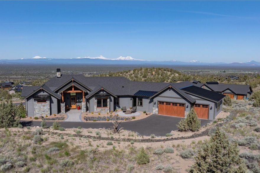 This stunning home offers panoramic views of the Cascade Mountains and Powell Buttes, with every room showcasing breathtaking scenery. Unwind on the front deck as you take in vibrant Brasada sunsets and embrace the tranquility of Central Oregon living. Inside, enjoy mountain rustic finishes and expansive windows that flood the great room and open kitchen with natural light, creating a warm, inviting space ideal for entertaining or relaxing. The primary suite features private deck access, a luxurious shower, and a spacious walk-in closet. Two guest bedrooms share a full bath, complemented by a dedicated den or media room with built in wine fridge and a well-appointed laundry room—each thoughtfully designed for comfort and views. Every bedroom connects you to the natural beauty beyond, blending interior elegance with nature. A spacious three-car garage provides ample storage, completing this exceptional home in the heart of Brasada Ranch.