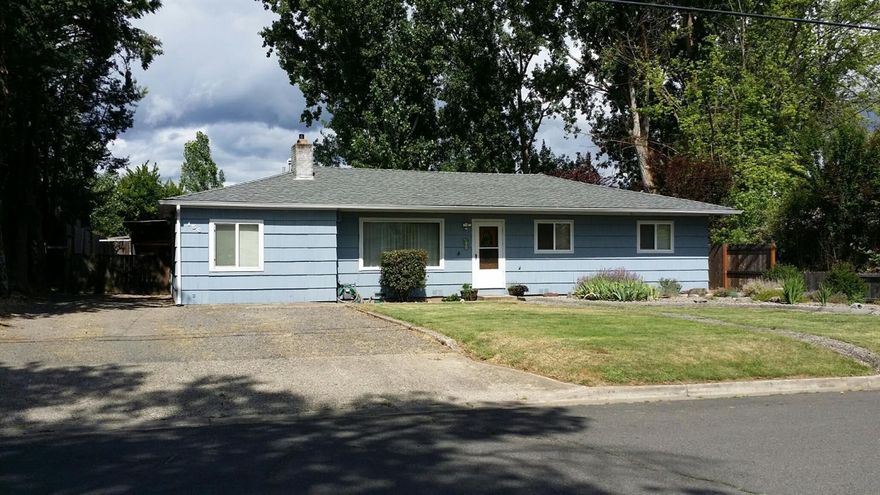 Country living close to town. Comfortable and quiet 3 bed, 1 bath home rests on a large .28 acre lot w/ a dbl car carport & 300 sq ft attached shop w/ room to spare to park an RV, boat & other toys. The 1484 sq ft home features an inviting livingrm w/ brick fireplace, built-in bookshelves, galley kitchen w/ large pantry, dining plus a bonus room! Recent updates incl. vinyl windows, front door & rear storm door, lighting, new comp roof in May 2017, exterior paint, refinished oak floors & new HVAC system in 2014, remodeled indoor laundry & kitchen w/ wood cabinets & Formica counters, updated interior doors & hardware in 2015, remodeled bathroom w/ tile bath/shower surround & tile floors in 2016. Large newly roofed covered back porch w/ 4 skylights is great for entertaining, a full privacy fenced back yard complete w/ expansive lawn and raised vegetable beds. Just a block from shopping, banking, and restaurants and just a half mile from Oak Grove Elementary School.